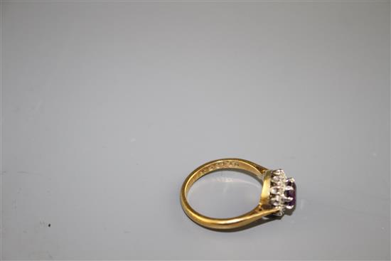 A modern 18ct gold, amethyst and diamond set circular cluster ring, size I, gross weight 3.2 grams.